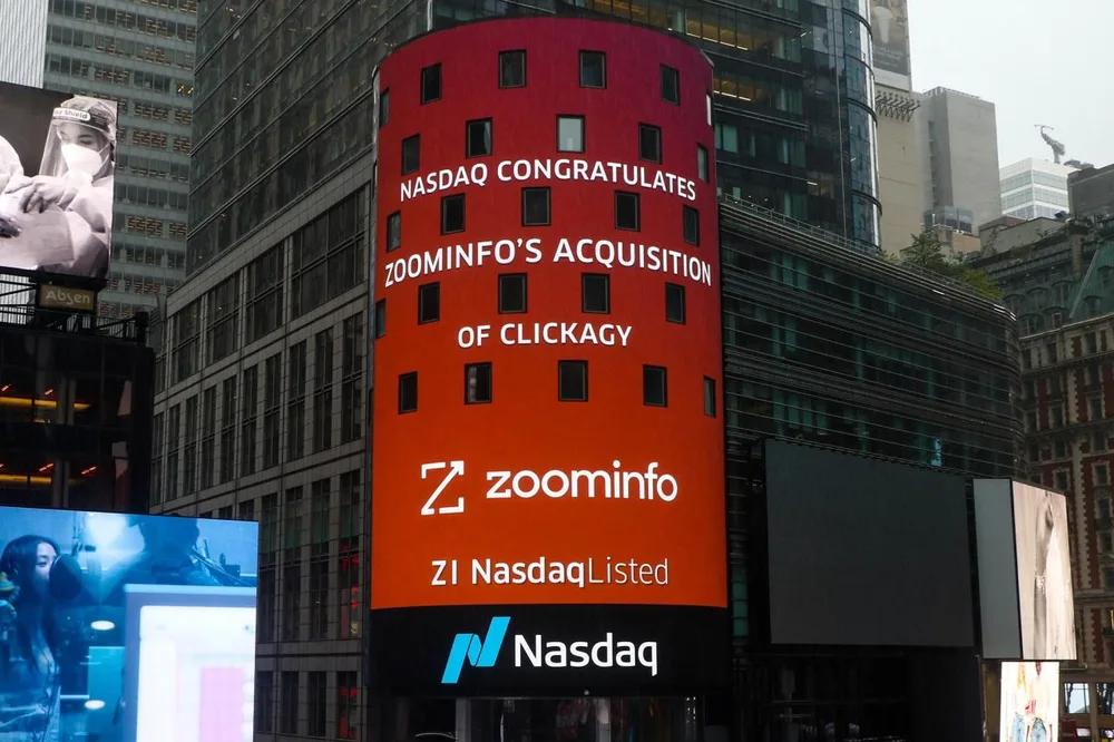 A Nasdaq billboard over Times Square reading: Nasdaq congratulates ZoomInfo's acquisition of Clickagy.